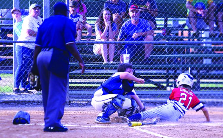 Keystone Heights’ Cy Cubbedge gets in safely at home plate in front of Melrose catcher Connor Finchum during Friday night’s District 5 Babe Ruth 12-and-under All-Star game in Starke. (ANTHONY RICHARDS / Palatka Daily News)