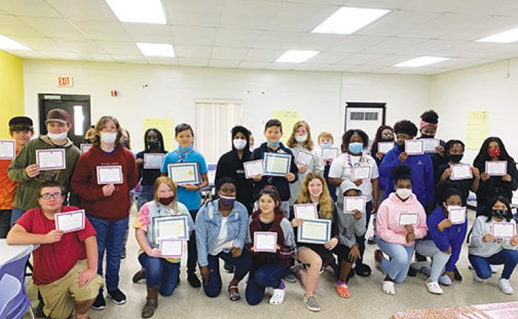 Seventh and eighth grade students who participated in a four-day Jobs for Florida Graduates camp at Jenkins Middle School hold the certificates they earned Friday, which was the last day.