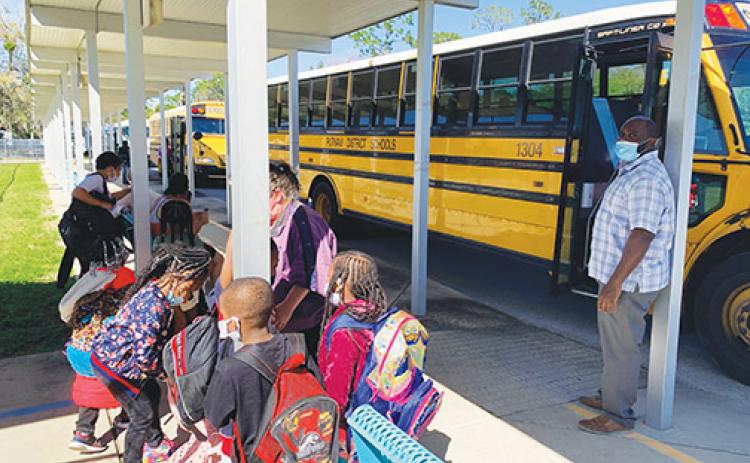 Mellon Elementary students board the bus at the end of a school day in March.