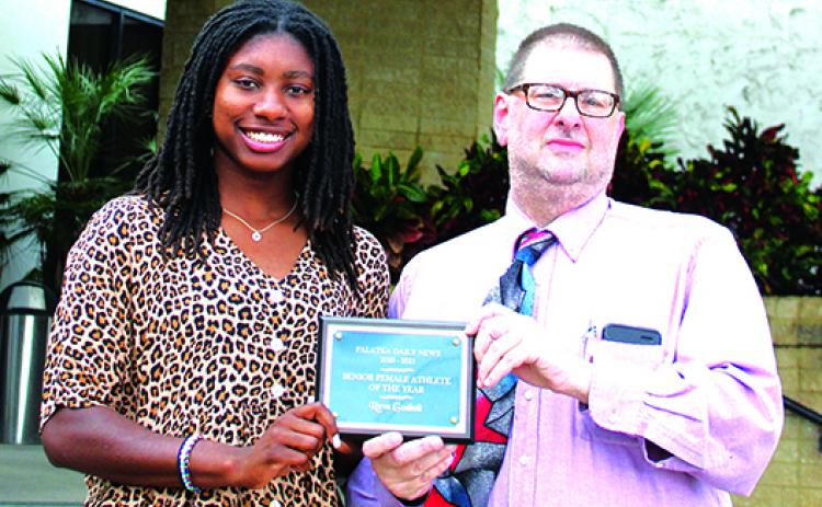 Recent Interlachen High graduate and three-sport standout Reva Godbolt is awarded the first-ever Daily News Senior Female Athlete of the Year honor by sports editor Mark Blumenthal. (ANTHONY RICHARDS / Palatka Daily News)