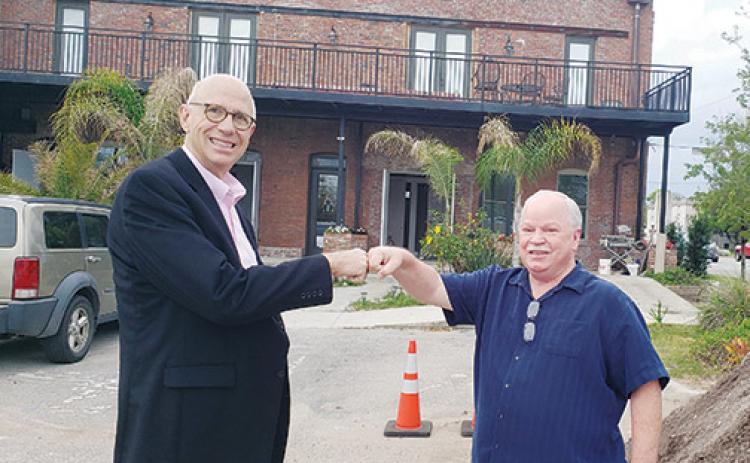 Robert Mills and Rusty Starr, co-chairmen of 1 Putnam’s Business Challenge Committee, stand in front of the building under renovation on the 100 block of Second Street in Palatka.