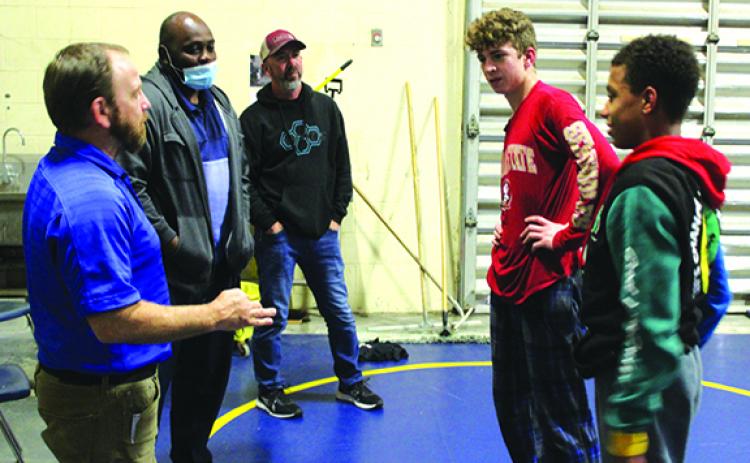 Palatka High School wrestling coach Josh White, left, and assistant coach Elysha Campbell, second from left, had memorable 2020-21 seasons. They chat with fellow assistant coach Richie Lewis, middle, and state wrestling qualifiers Brandon Lewis, second right, and Mikade Harvey in March. (MARK BLUMENTHAL / Palatka Daily News)