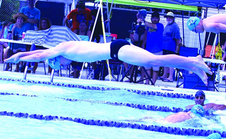 Robert Grace jumps in to swim the freestyle part of a 15-and-over Putnam Sharks relay team Saturday at Putnam Aquatic Center. The team won its relay. (ANTHONY RICHARDS / Palatka Daily News)