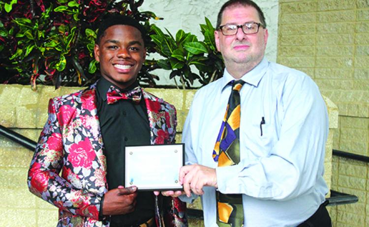 Palatka three-sport standout Delton Nealy Jr. receives his Daily News Senior Male Athlete of the Year plaque from sports editor Mark Blumenthal. (ANTHONY RICHARDS / Palatka Daily News)