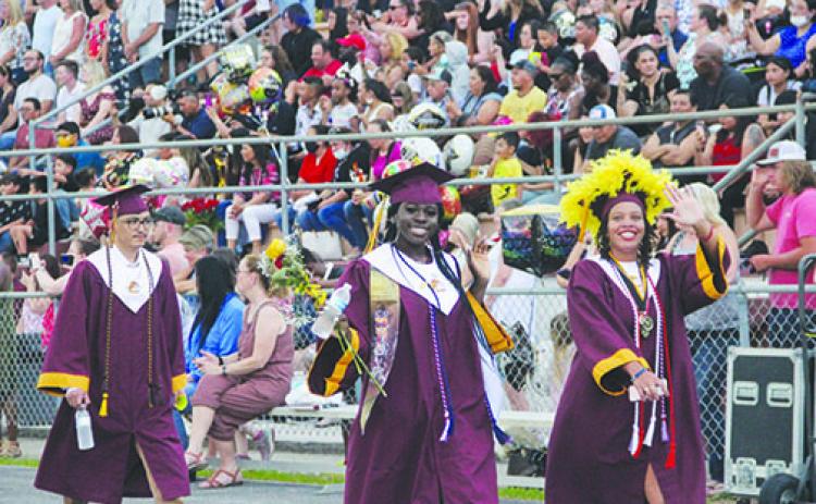 Crescent City graduates enter Wiltcher Stadium on Thursday night as their graduation ceremony gets underway.