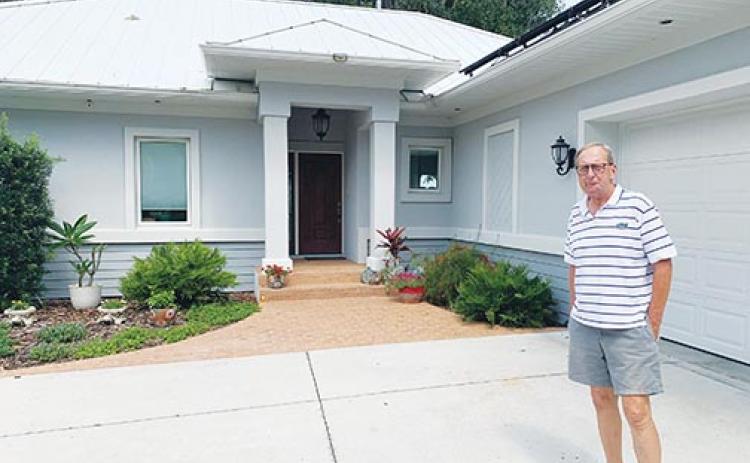 Homeowner David Kudlo stands outside his Satsuma home, which received a certification from the Florida Green Building Coalition last month for its energy efficiency.