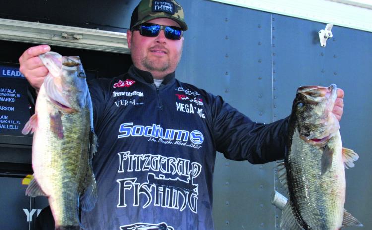 Trevor Fitzgerald holds up a few of his catches as he won the the FLW Toyota Series Southern Division Opening Bass Tournament in February 2020 on the St. Johns River. (GREG WALKER / Daily News correspondent)