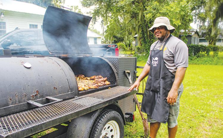 Xavier Thomas, owner of Golden Glory Seafood & More in Palatka, cooks chicken for nearly five hours Monday to celebrate Bread of Life moving back into its renovated building a few months ago and increasing its number of volunteers.