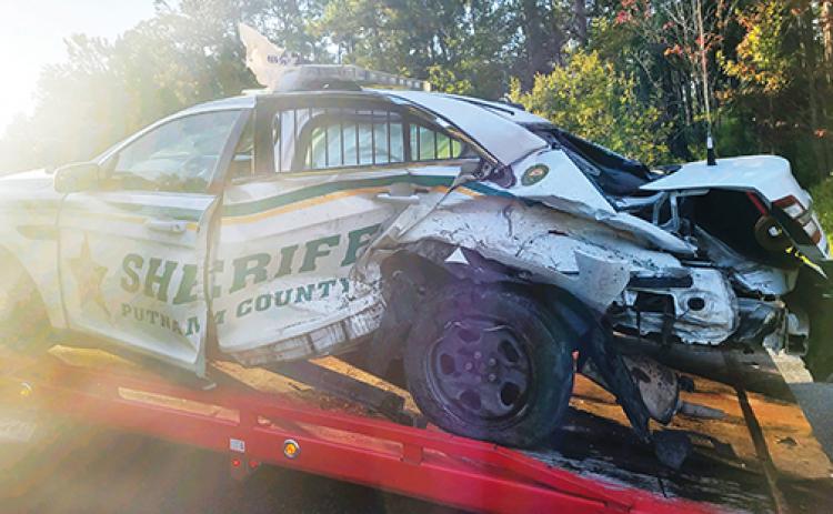 A Putnam County Sheriff’s Office patrol vehicle is loaded onto a tow truck after being involved in a crash.