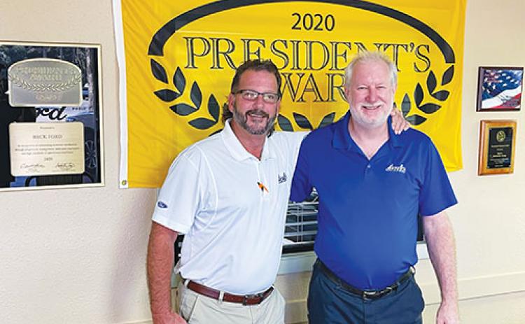 Beck Ford Service Manager Mark Roser stands with salesman Rick Fullerton in front of the dealership’s 2020 Presidents Award, which they received just months before the Platinum Blue award the Palatka dealership was given earlier in August.
