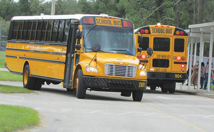 Putnam County School District buses get ready to pick up students Tuesday afternoon at Mellon Learning Center.