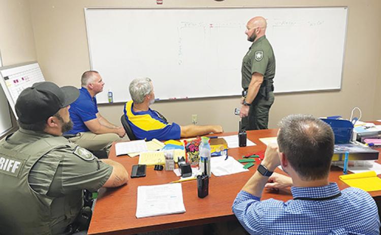 Members of the Putnam County Sheriff’s Office and Palatka Junior-Senior High School administration discuss pickup and drop-off routes in August.