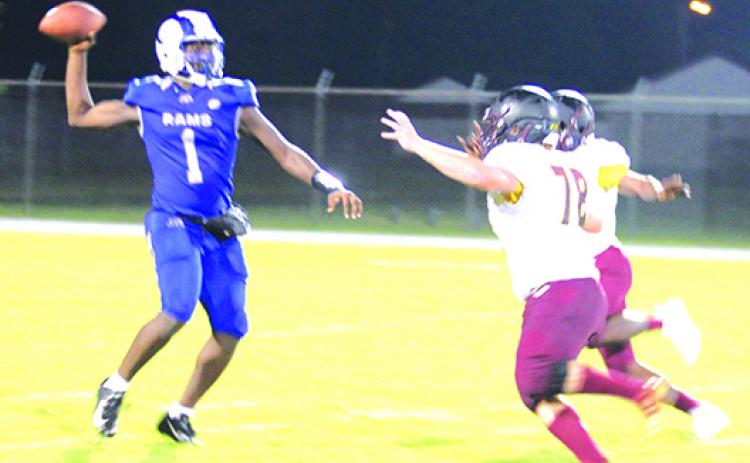 Interlachen quarterback Reggie Allen Jr., who has back-to-back 100-yard rushing games, tries to throw a pass against a pair of Crescent City defenders on Sept. 10, one of them being Luke Schulingkamp (78). (MARK BLUMENTHAL / Palatka Daily News)