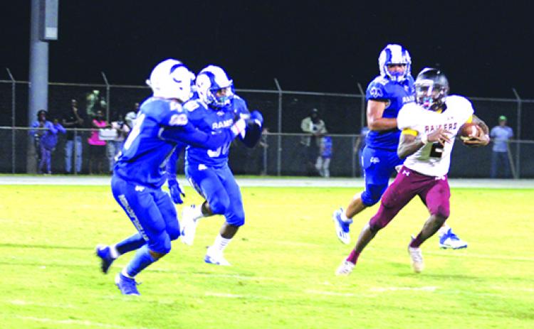 Crescent City’s Naykeem Scott (2), who ran for 288 yards in last week’s win over Trenton, tries to escape Interlachen defenders on Sept. 10. (MARK BLUMENTHAL / Palatka Daily News)