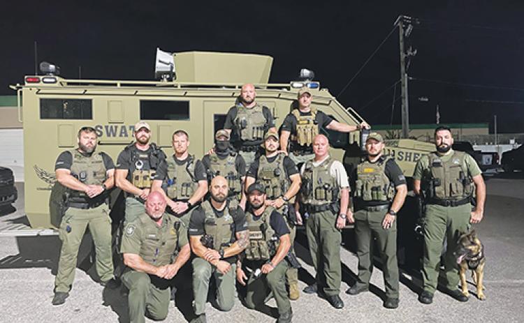 Putnam County Sheriff’s Office deputies gather early Sunday morning before heading to Nassau County to assist in the search for the suspect in the fatal shooting of a Nassau County Sheriff’s Office deputy.