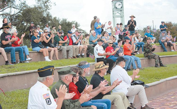 Community members applaud during a previous Veterans Day ceremony at the Palatka riverfront amphitheater.