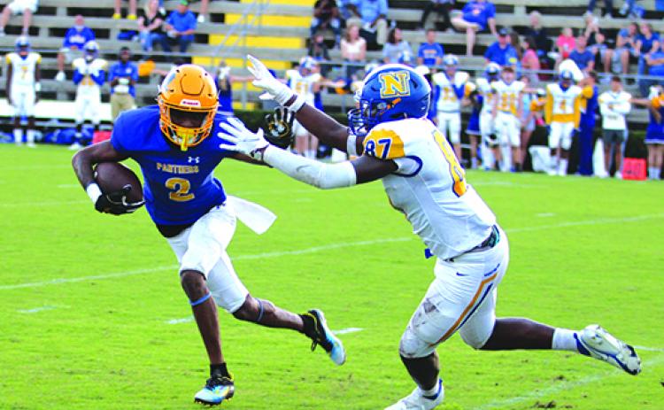 Palatka’s Roderris Passmore tries to avoid the tackle attempt of Newberry’s Gage Thompson during the first quarter of Friday night’s game. (MARK BLUMENTHAL / Palatka Daily News)