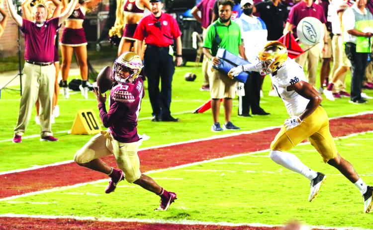 Florida State starting quarterback Jordan Travis outraces a Notre Dame defender to score a touchdown during Sunday night’s overtime thriller in Tallahassee. (GREG OYSTER / Special To The Daily News)