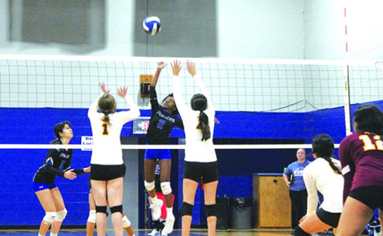 Interlachen’s Alyssa Matthews tries to put a kill attempt between Crescent City’s Riley Arroyo (1) and Aleni Carbajal during Tuesday’s match. (MARK BLUMENTHAL / Palatka Daily News)