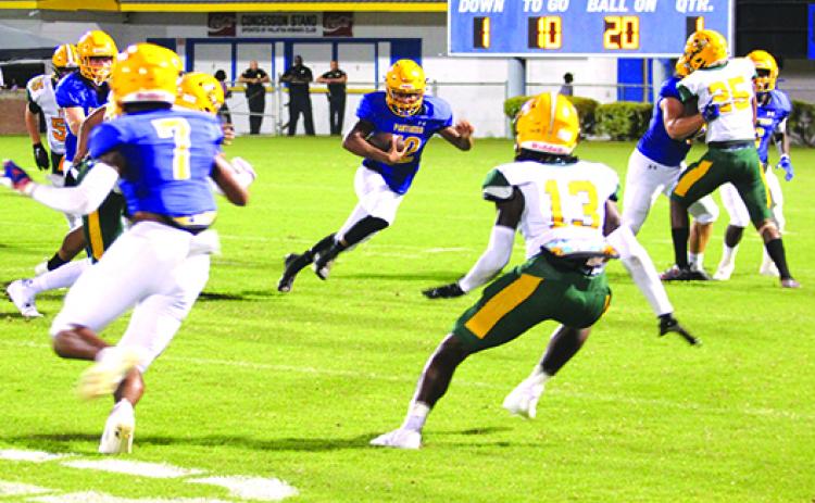 Palatka’s Jamarrie McKinnon (12), looking for room to move against Yulee in the preseason jamboree on Aug. 20, will share quarterback duties with Matthew Lands against Eustis. (MARK BLUMENTHAL / Palatka Daily News)