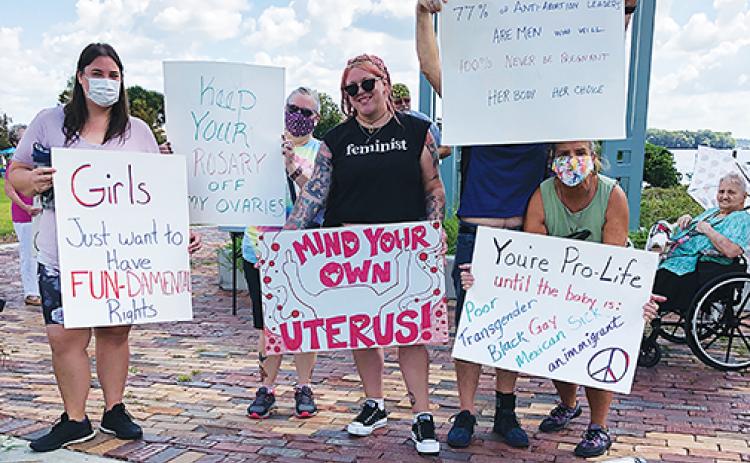 Participants in the Palatka March for Women’s Reproductive Rights gather at the Millennium Clock Tower in Palatka before the event begins Saturday afternoon.