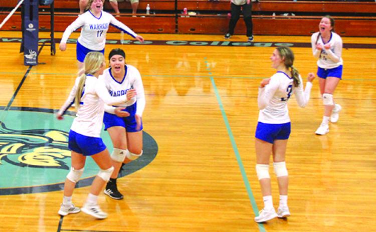 Peniel Baptist Academy volleyball teammates celebrate a fourth-set kill by Brook Williams (front, left) during Thursday night’s victory at Tuten Gymnasium against Crescent City. (MARK BLUMENTHAL / Palatka Daily News)