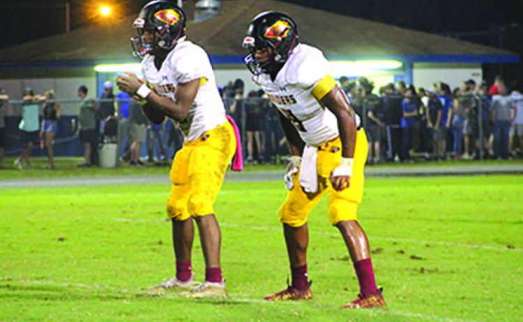 Crescent City quarterback Naykeem Scott (left) waits for the snap from center with running back Elijah Hernandez set for the play. (COREY DAVIS / Palatka Daily News)