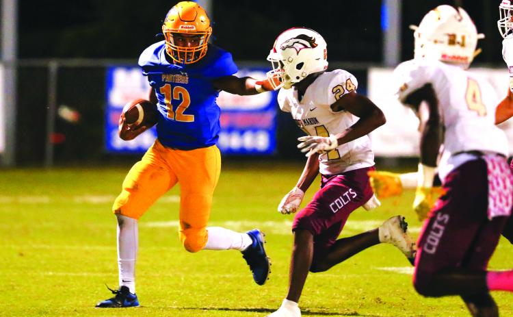 Palatka quarterback Jamarrie McKinnon tries to push his way for yardage against North Marion’s Di’amontae Faison during Friday night’s game at Bennett-Cooper Field at Veterans Memorial Stadium. (GREG OYSTER / Special To The Daily News)