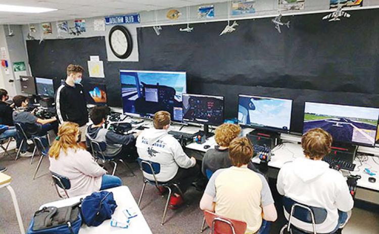 Q.I. Roberts Junior-Senior High School students participate in a flight simulation at the school.