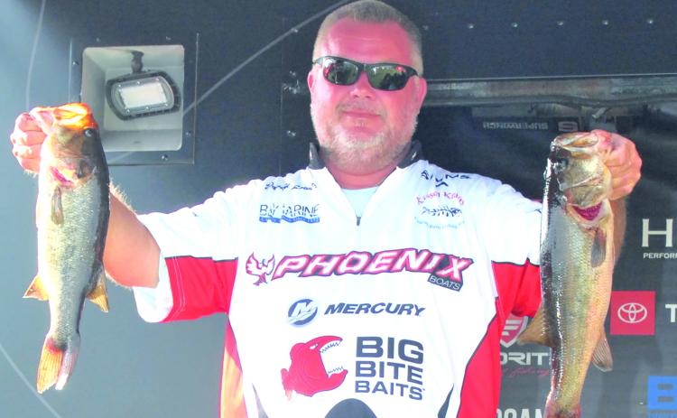 David Lowery holds up two of his winning fish that sealed his victory at the MLF Phoenix Bass Fishing League regional tournament. (GREG WALKER / Daily News correspondent)