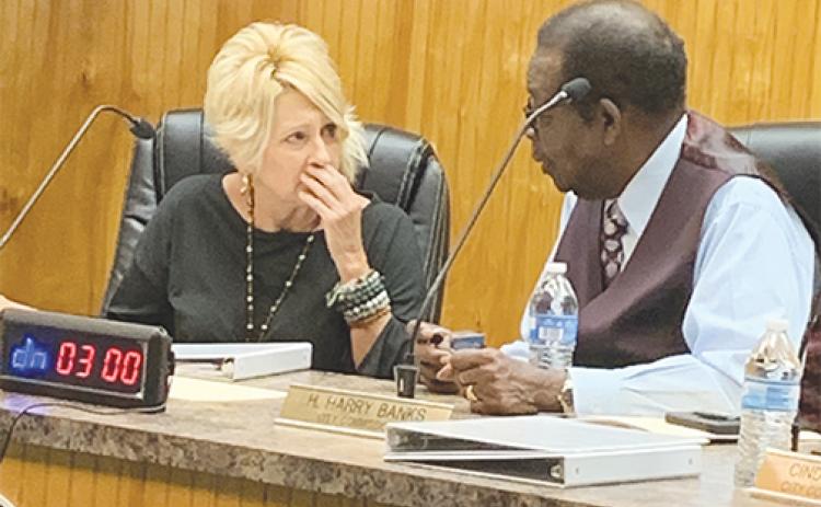 Crescent City Mayor Michele Myers confers with Commissioner Harry Banks during a commission workshop Thursday.