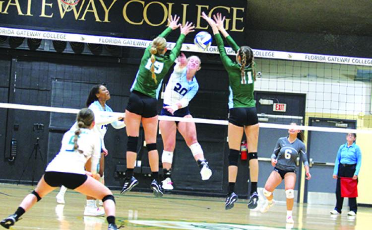 St. Johns River State College’s Cassidy Casey (20) sends a kill down past Lake-Sumter’s Emma Rome (15) and Courtney Wagner during Friday’s winners’ bracket final at Florida Gateway College. (MARK BLUMENTHAL / Palatka Daily News)