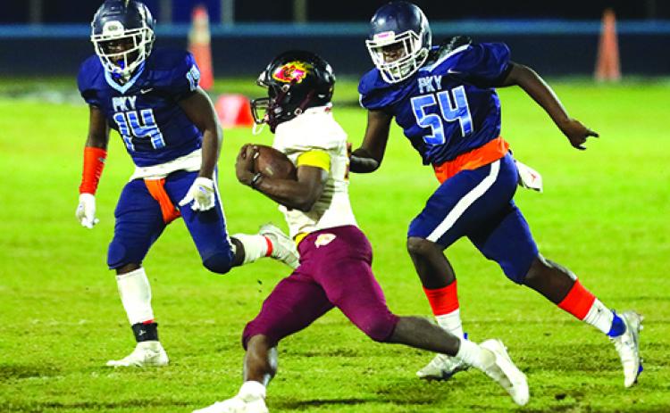 Crescent City running back Dazail Dennis tries to outrun P.K. Yonge defenders Ernest Davis (14) and Kyler Ingram during Friday night’s FHSAA Region 1-3A first-round matchup in Gainesville. (BRAD McCLENNY / Special to the Daily News)