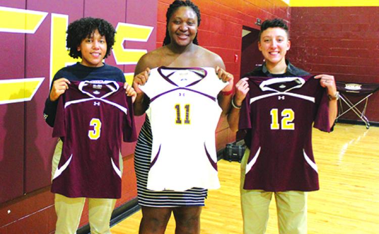 Daily News 2011 All-County volleyball standouts (from left) Vicktoria Williams, Kayshia Brady, the county’s player of the year, and Alexis Sepulveda show off their jerseys they wore during Crescent City’s FHSAA 1A Final Four season that year when that 2011 team was honored in a ceremony on Sept. 9. (MARK BLUMENTHAL / Palatka Daily News)