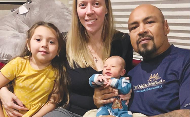 From left: Somiliyah Ortega, 4; her mother Makayla Ortega; newborn Silas Ortega, born Nov. 8; and father and husband Javier Ortega pose for a photo at their home. 