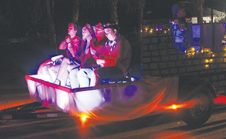 Members of a local church group ride in a float during the 2019 Palatka Christmas Parade.