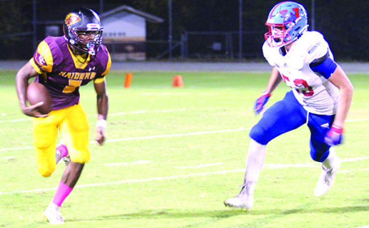 Crescent City Junior-Senior High quarterback Naykeem Scott (left), shown going for yards on the ground against Jacksonville Wolfson on Oct. 22, had the rare distinction of running for over 1,100 yards and passing for over 1,100 yards this season. (MARK BLUMENTHAL / Palatka Daily News0