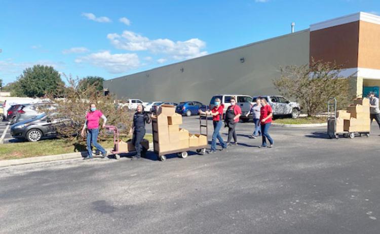 Winn-Dixie employees in Crescent City push some of the turkeys to be loaded into emergency vehicles. 
