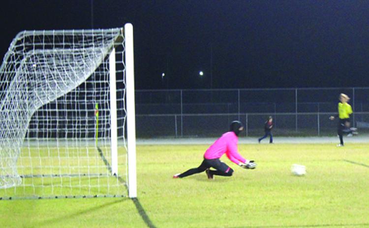Interlachen goalkeeper Jacob Carnes goes down to make a diving save during the first half of Tuesday’s game against Baker County on Tuesday. (MARK BLUMENTHAL / Palatka Daily News)