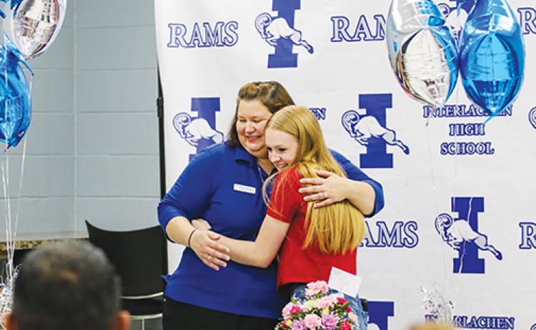 Take Stock in Children mentor Wendy Hansford hugs Williams after the student found out she won the prize.