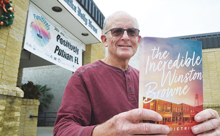 Bob Lee of One Book, One Putnam holds up this year’s reading selection chosen for the community reading program that is heading into its 18th year.