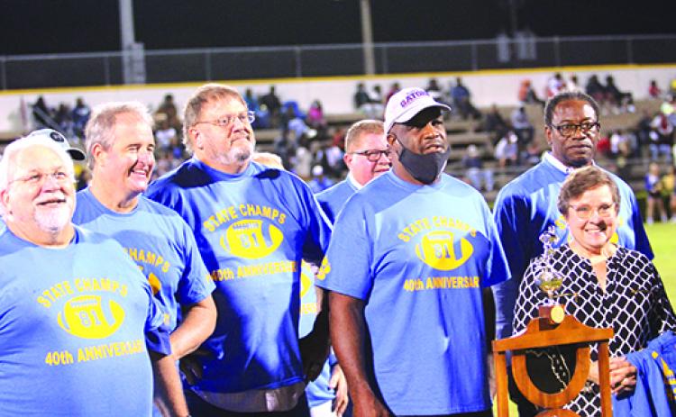 Members of the 1981 state 3A champion Palatka High School football team pose with Susan Lyle, the widow of head coach Bob Lyle, and the state championship trophy in a ceremony held at halftime of the Oct. 29 game against Menendez. From left are Gary Hathy, Brian Hill, Willie Tilton, Preston Clark, John L Williams and Darryl Oliver. (MARK BLUMENTHAL / Palatka Daily News)
