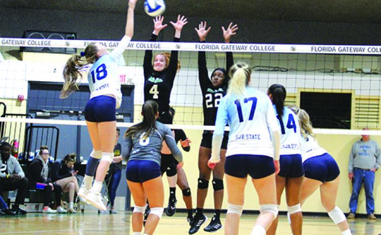 St. Johns River State College’s Mayya Kucherova looks for a spike attempt over Lake-Sumter’s Erin Ellis (4) and Taylor Lawrence during their conference tournament game on Nov. 6 at Florida Gateway College in Lake City.  