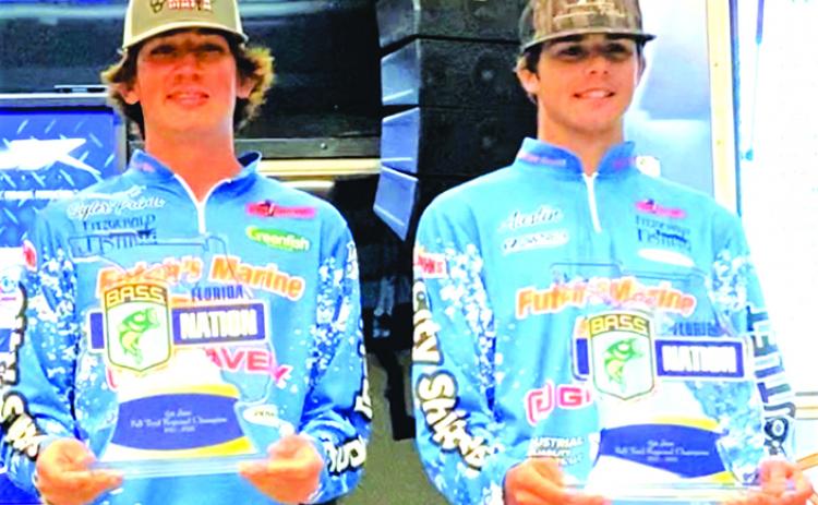 Syler Prince, left, and Austin Peters pose with trophies after capturing top points honors in the fall division of the Florida BASS Jr./Sr. High School competition. (GREG WALKER / Daily News correspondent)