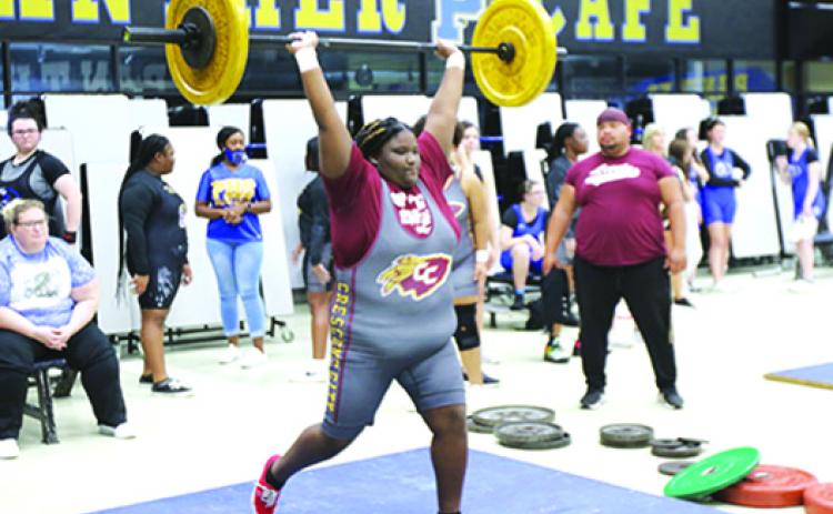 Unlimited division competitor Paris Clemons delivers a successful clean-and-jerk lift at the Putnam County Championship in December. (COREY DAVIS / Palatka Daily News)