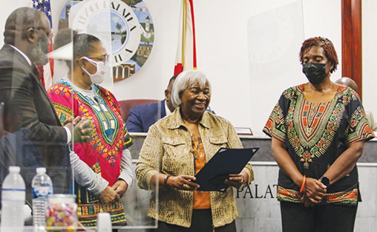 Ruth E. Benjamin, center, smiles as she stands next to other founders of the African-American Cultural Arts Council of Putnam County on Thursday after accepting the city of Palatka’s proclamation for Black History Month.
