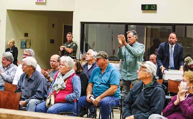Putnam County residents clap in approval after the Zoning Board of Adjustment votes down a special use permit application to distribute biosolids a Lake Como property.