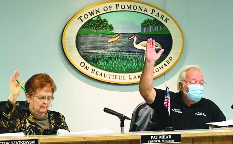 Photo by Al Krombach/Special to the Daily News. Pomona Park Mayor Joe Svingala and Councilwoman Pat Mead cast their votes for a new town attorney Tuesday. 