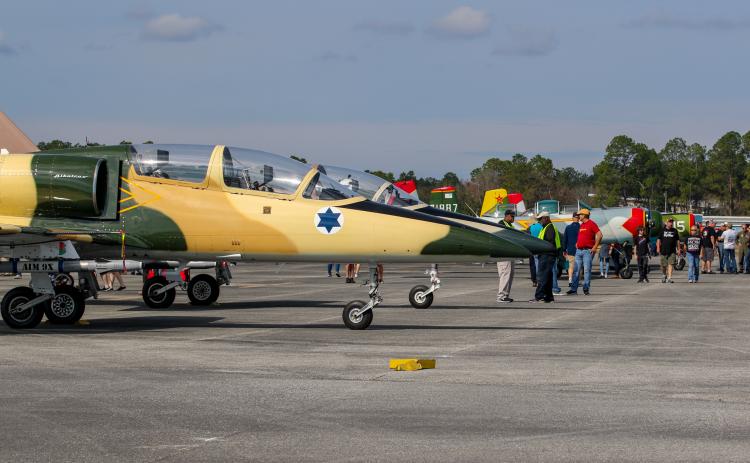 Attendees explore rows of vintage airplanes and warplanes at the 11th Annual Fly-in and Classic Car Show on Saturday. 