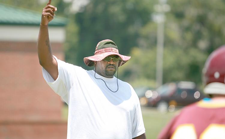 Clarence "Pooh Bear" Williams points at the sky during a football practice at Crescent City High.